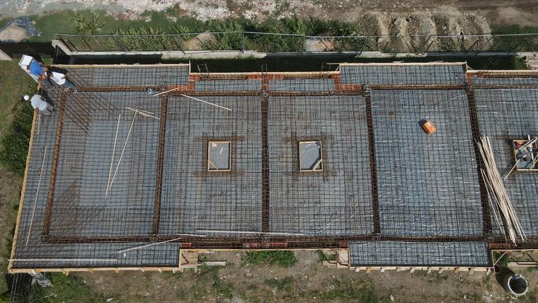 Placă de beton armat în lucru, fotografiată vertical din aer, cu armătura montată pe toată suprafața